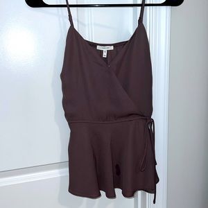 Peplum tank top with adjustable tie feature on the side